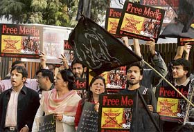 Journalists protest against curbs on the media outside a closed office of ARY One World, a leading private television network, in Islamabad