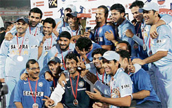 Members of the Indian team celebrate with the Indian Oil Trophy after the end of the fifth ODI against Pakistan in Jaipur