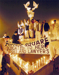 Pakistan lawyers and civil rights activists light candles during a protest in Peshawer