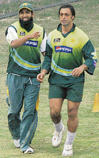 Shoaib Akhtar (R) and Mohammed Yousuf warm up during a training session at the Ferozeshah Kotla ground.