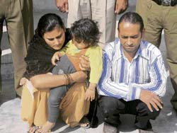 A couple, accused of looting a bank manager, in police custody in Hisar.