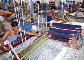 Employees at work at a pit loom factory in Panipat