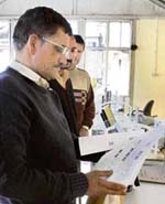 Officials of  the DCs office scan voters' lists in Shimla. 