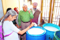 Health Minister Luxmi Kanta Chawla along with health secretary T. R. Sarangal inspects drums of synthetic milk in Rajpura