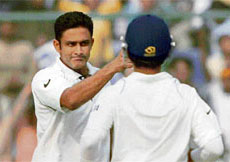 Anil Kumble celebrates after taking the wicket of Kamran Akmal on the first day of the first Test at the Ferozeshah Kotla ground in New Delhi on Thursday.