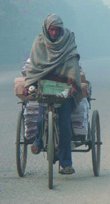 A rickshaw puller enters fog-enveloped Delhi from Sahibabad in the morning on Friday.
