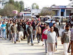 BJP workers take out a protest march at Jassur on Friday.