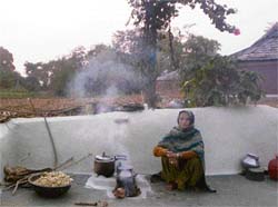 A woman of Kuthera island cooks meals on a chullah.