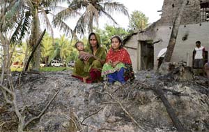 Victims of violence: Villagers sitting outside their burnt houses at Satengabari in Nandigram