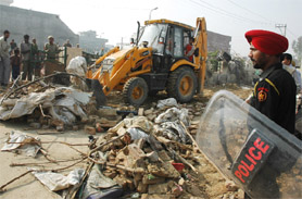 JCB machines demolishing the shanties at Tagore Nagar in Bathinda on Sunday.