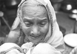 Rahima Begum, 80, weeps after losing her grandson during a storm at Bakerganj, south west of Dhaka.