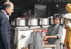 Labour Officer C.L. Kalia makes queries about the childs age washing utensils at a dhaba during an inspection to check on child labour in Ambala on Monday.
