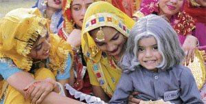 A child, dressed up as former President APJ Abdul Kalam, is all smiles as he waits for his turn to go on stage during a bal mela held at Baradari Gardens in Patiala.