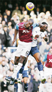 West Hams Carlton Cole (L) fights for the ball with Tottenham Hotspurs Didier Zokora during their English Premier League soccer match at Upton Park in east London on Sunday.
