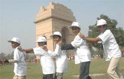 Children make a human chain to press for the abolition of child labour at the India Gate in the Capital on Thursday.