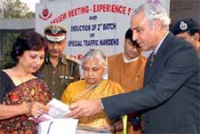 Lt Governor Tejendra Khanna presents a traffic kit to an officer at the induction of the second batch of special traffic wardens in the Capital on Thursday.