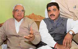 Former Chief Minister Bhajan Lal (left) addresses a press conference in Karnal on Thursday. 