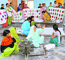 Women make durries at Nari Yuva Kender in Islamnagar village in Karnal.