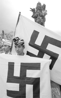Balinese hold a banner with a Hindu symbol during a demonstration to urge the Malaysia government to stop discrimination against Malaysian Hindus, in Denpasar on the resort island on Bali on Thursday.