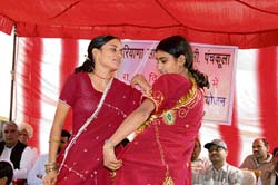 Schoolchildren present a item during a function organised by the Haryana Sahitya Akademi at Kajalheri village in Fatehabad on Saturday. 