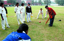 Kiran Bedi practises her cricketing skills with members of the Women's XI during the 8th CRY Cadence Corporate special match for the girl child, at Modern School, Barakhamba Road in the Capital