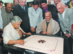 DPCC president JP Aggarwal strikes an opening move on carrom to inaugurate the Delhi State Carrom Championship, in memory of freedom fighter Ram Charan Aggarwal in the Capital 