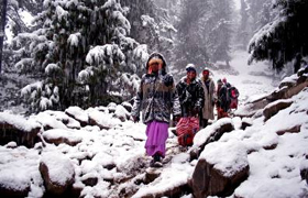 Tourists enjoy snowfall in Gulmarg, some 50 km from Srinagar