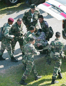 A Malaysian paratrooper, who survived a fall into the sea, is carried into an ambulance after an incident while training for the Langkawi International Air Show on Langkawi Island, in Malaysias northern Kedah state