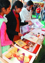 Visitors at Bathinda Book Fair taking a look at Saddam Hussein's poster. Shaheed Bhagat Singhs poster was also sold at the same counter