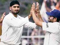 Harbhajan Singh celebrates with team mate Sachin Tendulkar after taking the wicket of Shoaib Akhtar during the second Test match at Eden Gardens in Kolkata on Monday.
