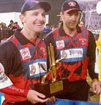 Darren Maddy (L) of Kolkata Tigers holds the Man-of-the-Match trophy as captain Craig McMillan looks on after their team beat Chandigarh Lions in the ICL Twenty20 match at the Tau Devi Lal Stadium in Panchkula on Sunday.