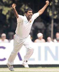 Muttiah Muralitharan celebrates taking the wicket of Englands Paul Collingwood to become Test crickets leading wicket-taker with 709 wickets during the third day of their first Test against England in Kandy on Monday.