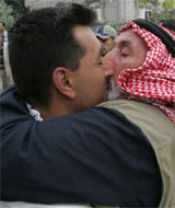 A newly-released Palestinian prisoner hugs his father as he arrives home in the southern Gaza Strip town of Khan Younes on Monday.