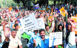 Public sector employees raise slogans during a demonstration to protest against disinvestment, privatisation and SEZ at Parliament Street in the Capital