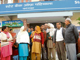 Old pensioners and widows outside the State Bank of Patiala branch at Kangra on Tuesday.