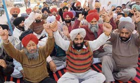 Patwaris of Mohali district protest outside the deputy commissioner’s office in Mohali