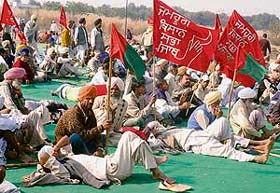 Demonstrators bask in the sun during a rally organised by 17 organisations from Punjab against the privatisation spree of the state government