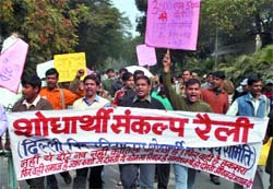 Members of the Delhi University Research Association demonstrate for the immediate release of fellowship for research students at North Campus in the Capital on Thursday.
