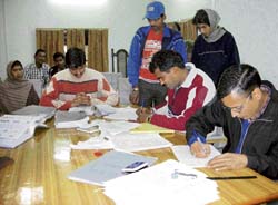 With the EC making voter cards mandatory, residents of Dharamsala filling in applications for these cards at the Zila Parishad hall on Thursday. 