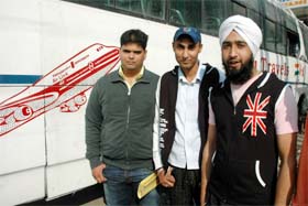 Passengers wait to board an airport bus in Jalandhar