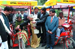 Chief Minister Sheila Dikshit gives MTNL's Mobile PCOs to the physically challenged at her residence in the Capital on Sunday.