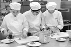 Students of Tourism Academy Sentosa preparing a meal during training