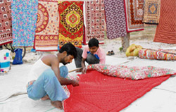 Workers give the final touches to a quilt on the roadside in Sector 7, Karnal,