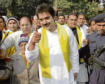 Suspended Congress MP Kuldeep Bishnoi, accompanied by supporters, makes a thumbs-up sign before going to meet Haryana Governor A.R. Kidwai to submit a memorandum at Haryana Raj Bhawan, Chandigarh, on Wednesday.