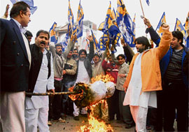 Bahujan Samaj Party activists burn an effigy of health minister Pt Mangat Ram Sharma for paying no attention to his department in Jammu on Wednesday. 