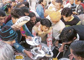 A scramble for free food after a BJP rally addressed by Prem Kumar Dhumal in Tirlokpura, near Kala Amb