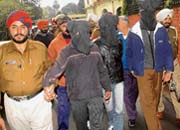 The three arrested being taken away by policemen after being presented before mediapersons in Phagwara on Thursday.