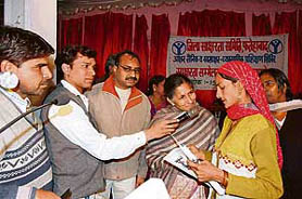 Bala Devi reads out lines from a handbook in front of minister of state for housing and revenue Savitri Jindal at a convention in Fatehabad on Saturday.