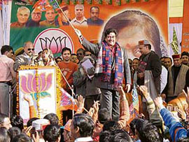 Actor-turned-politician Shatrughan Sinha greets supporters waving a BJP flag during a rally at Nahan on Saturday.