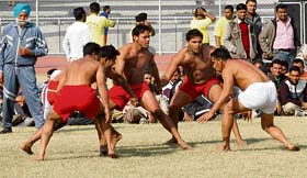 Players grapple during a match for the America-Canada Kabaddi Cup Tournament at Guru Nanak Stadium in Ludhiana